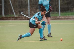 A player at Chippenham Hockey Club photographed mid shot, bracing to strike the ball