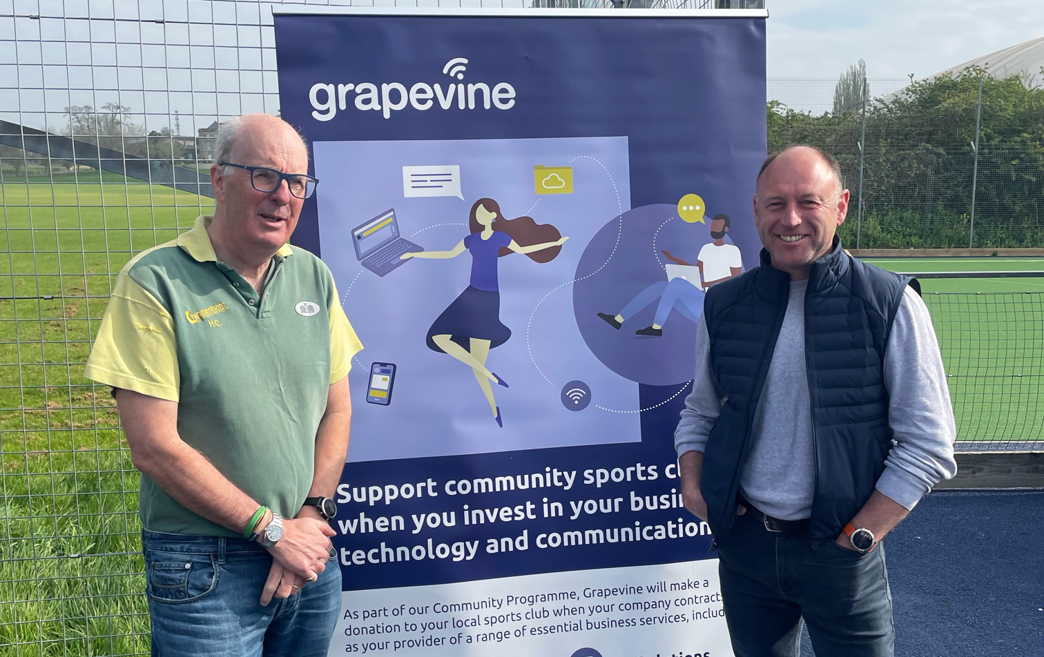 Staff from Chippenham Hockey Club stand alongside the Grapevine Community Programme pull up banner.